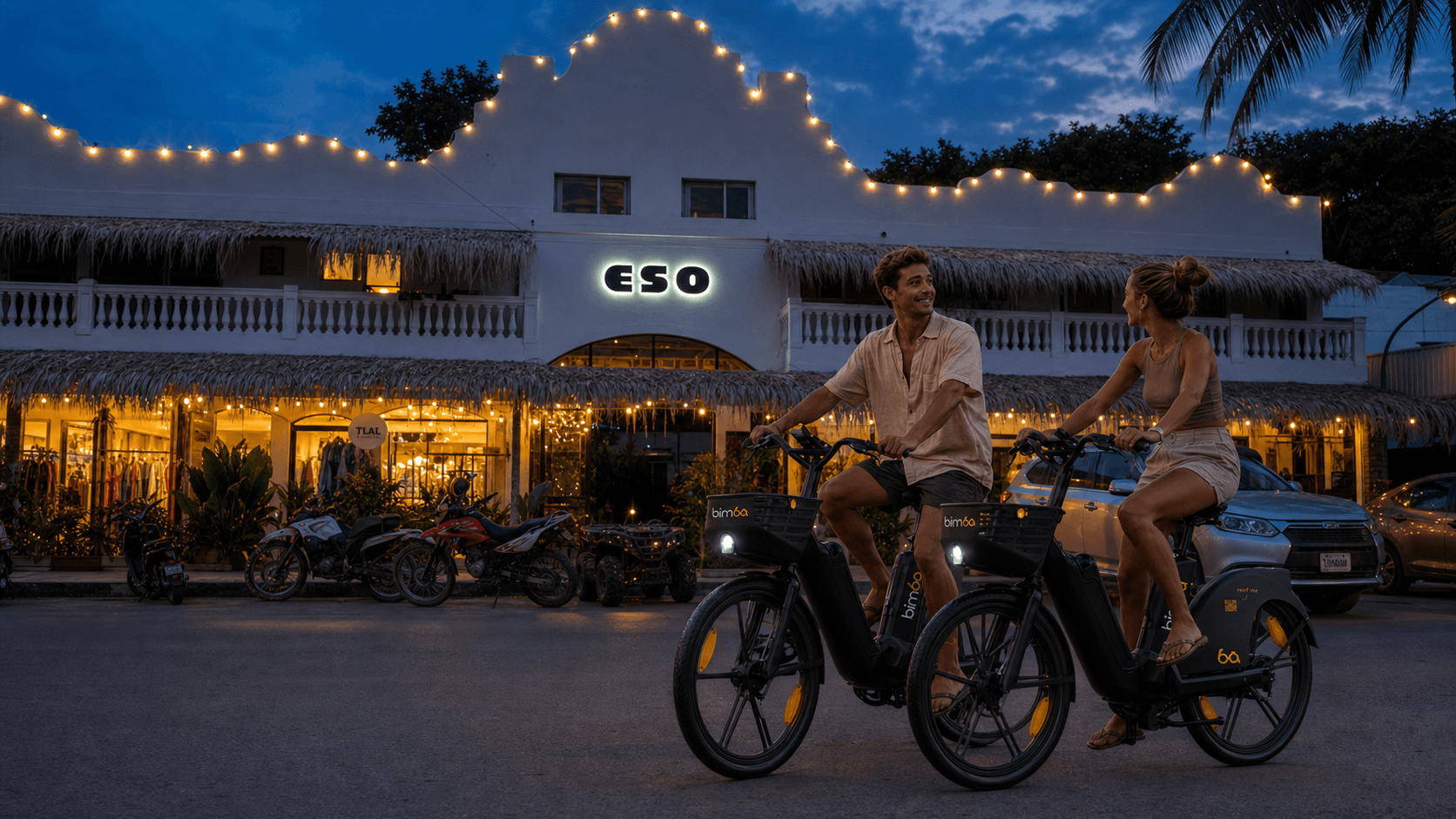 Two riders on Bimba electric bikes in Santa Teresa after sunset