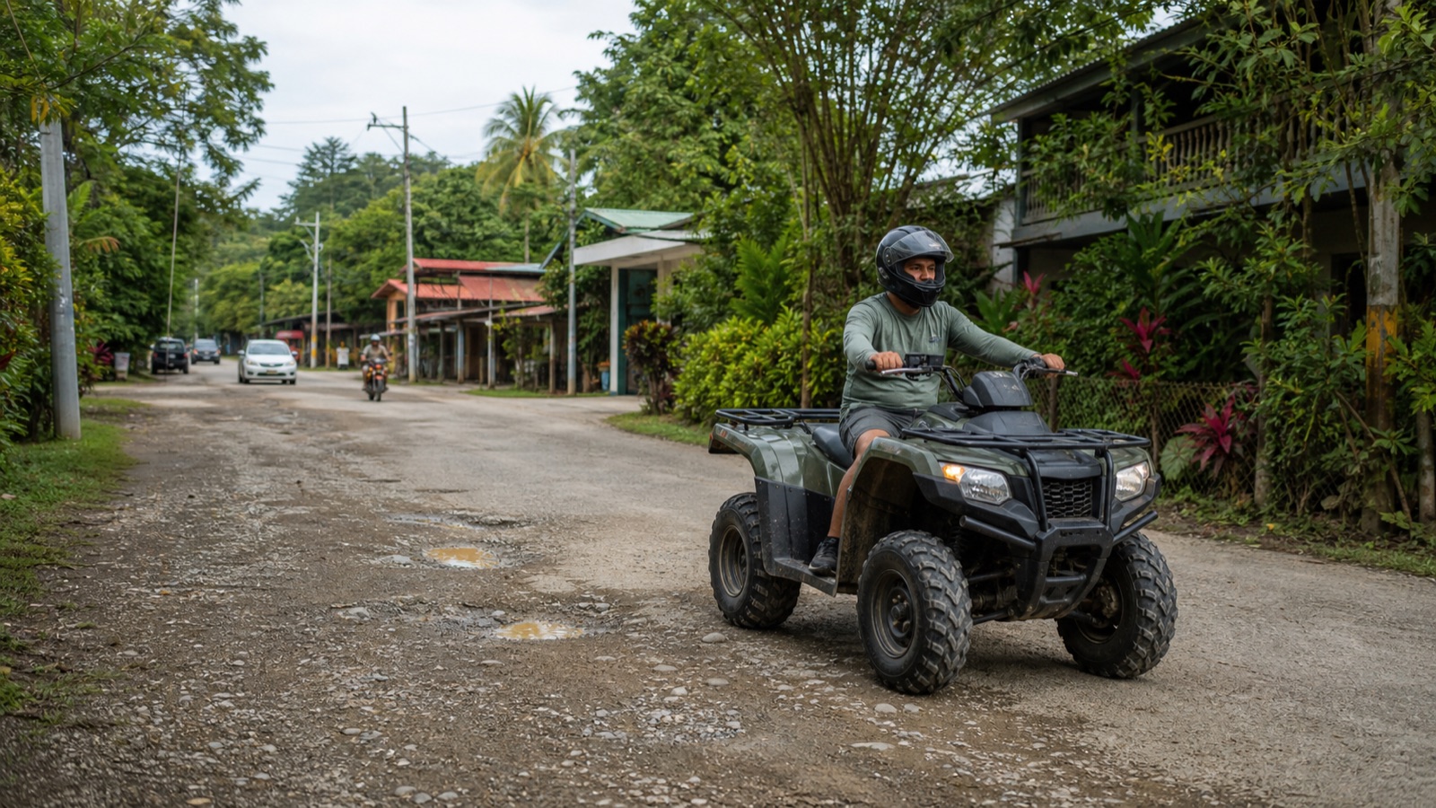 Helmeted ATV driver riding conservatively on an uneven public road in Santa Teresa