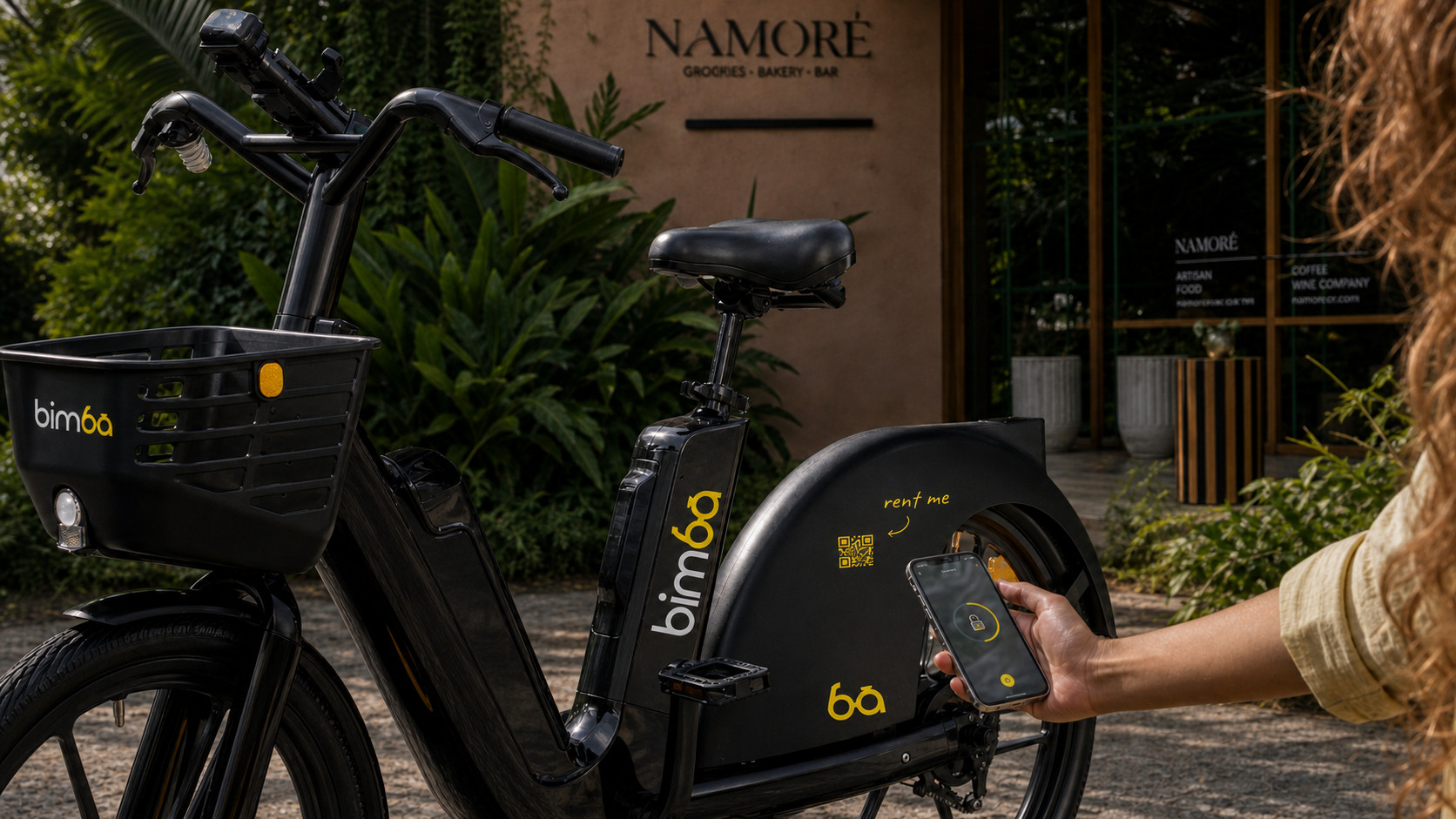 A rider scanning the QR code on a Bimba electric bike outside Namoré in Santa Teresa, Costa Rica