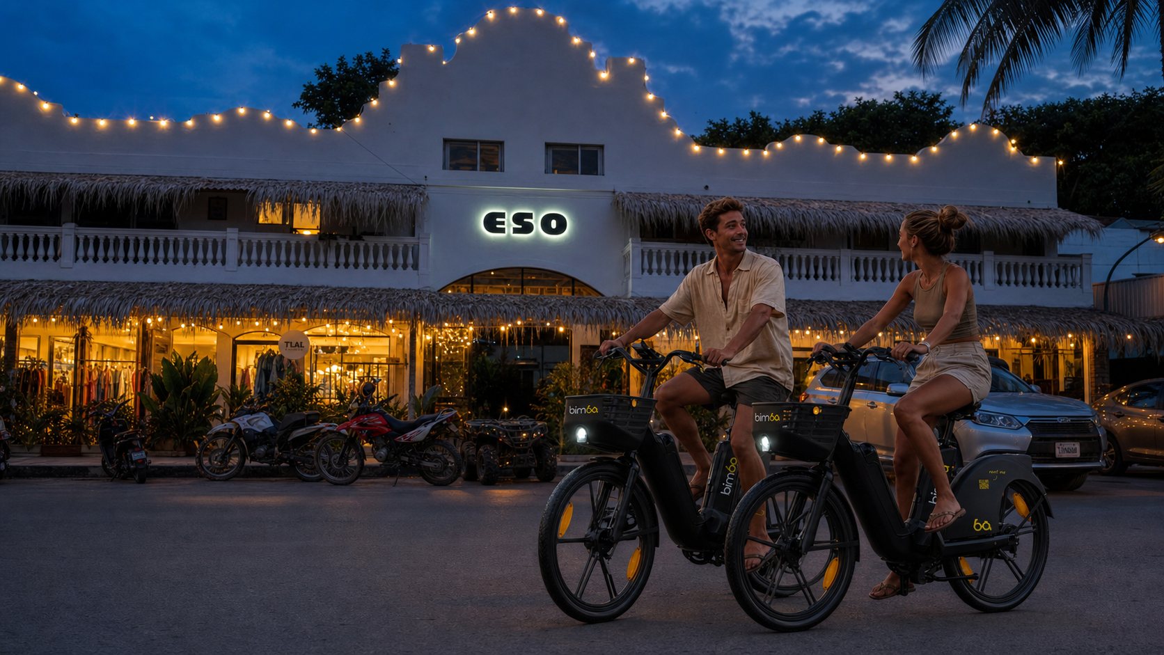 Two riders on Bimba electric bikes in Santa Teresa after sunset