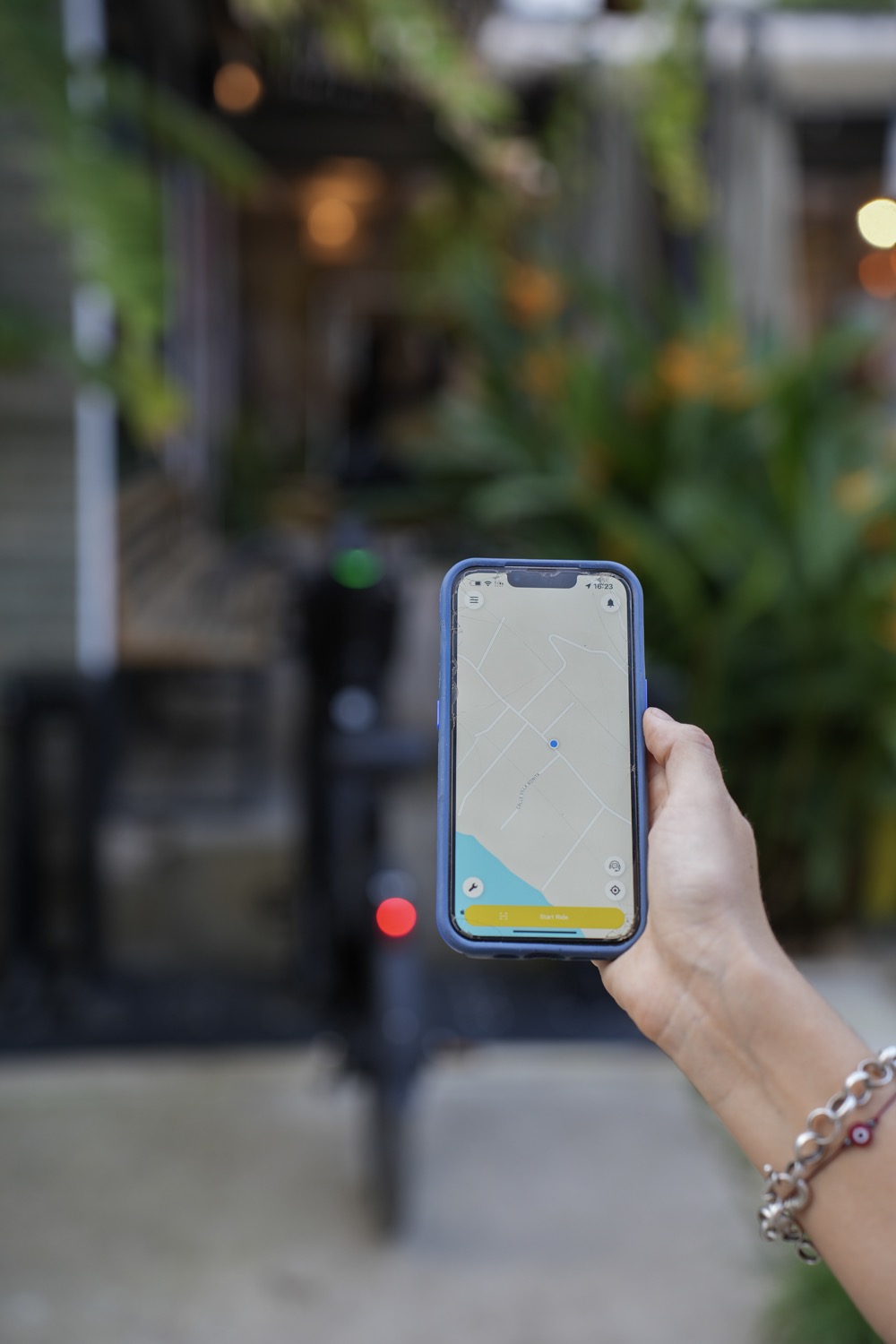 Bimba app live map displayed beside an electric bike outdoors