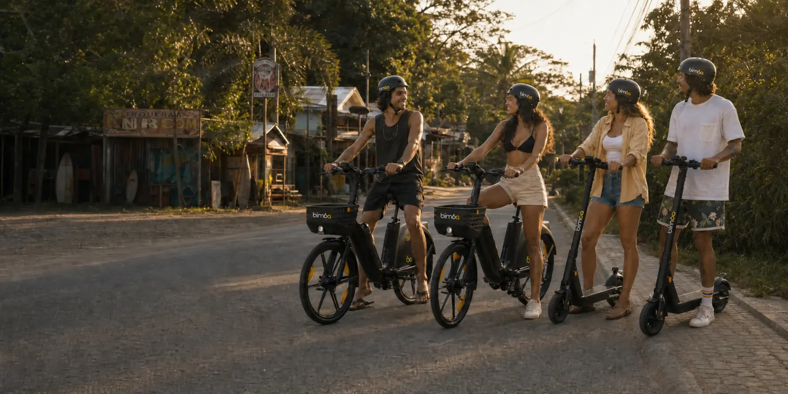 Bimba riders with shared electric bikes and scooters on the main road in Santa Teresa, Costa Rica