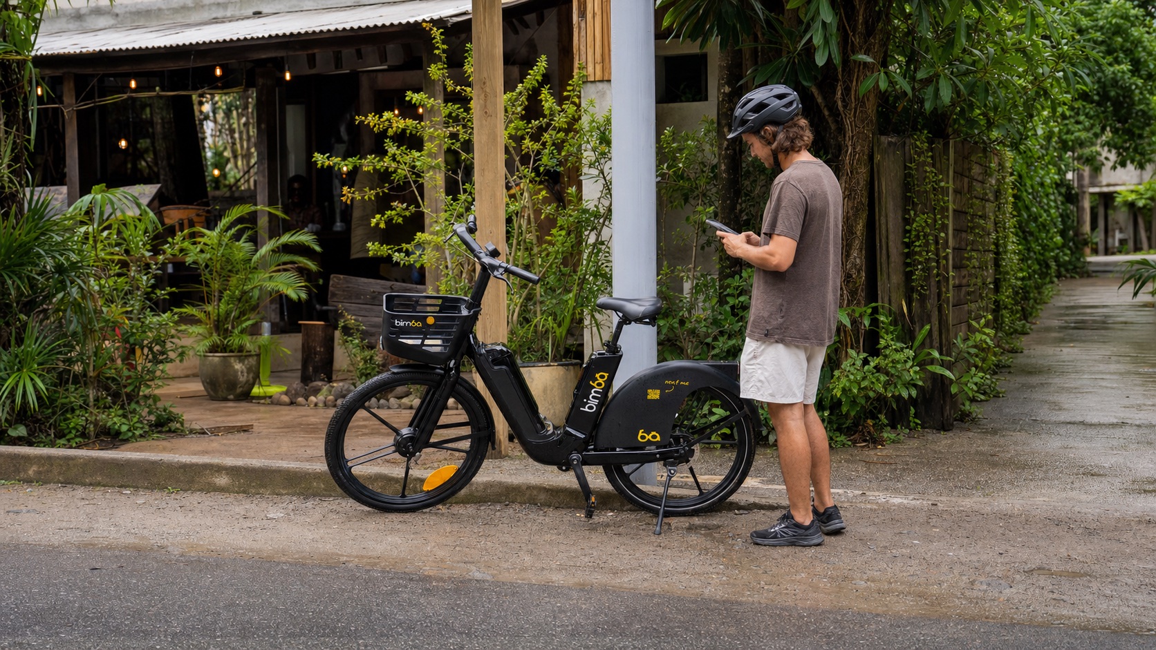 Traveler ending a Bimba ride after parking the e-bike upright without blocking a walkway