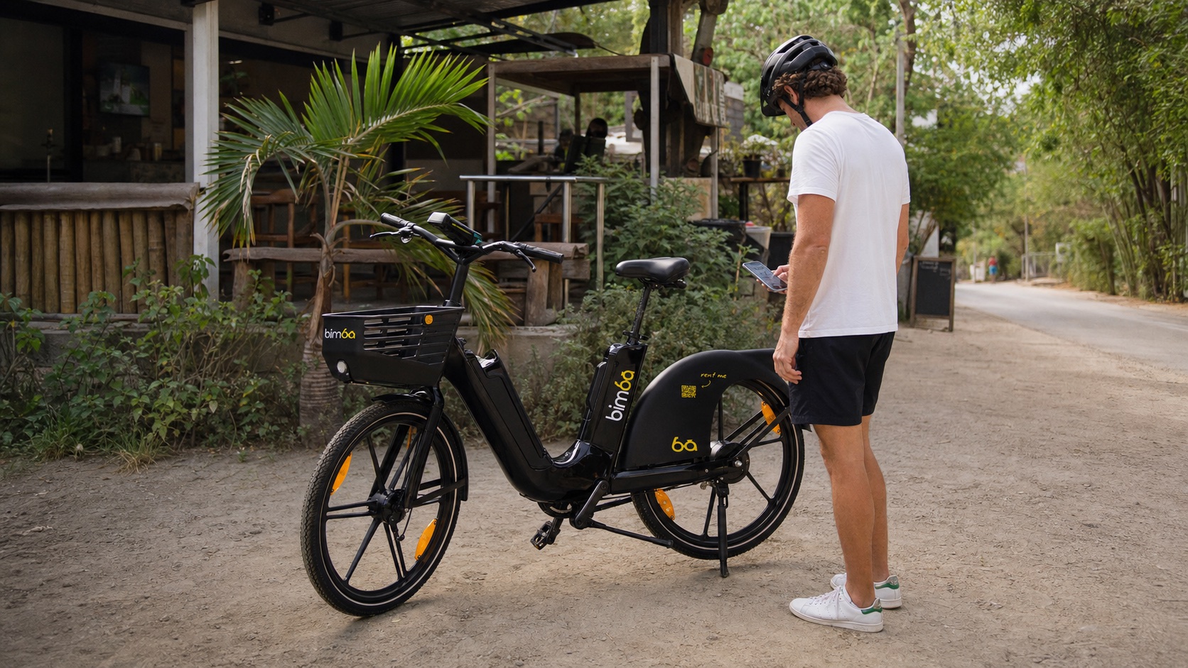 Helmeted traveler scanning the QR code on a Bimba e-bike beside a tropical Santa Teresa cafe