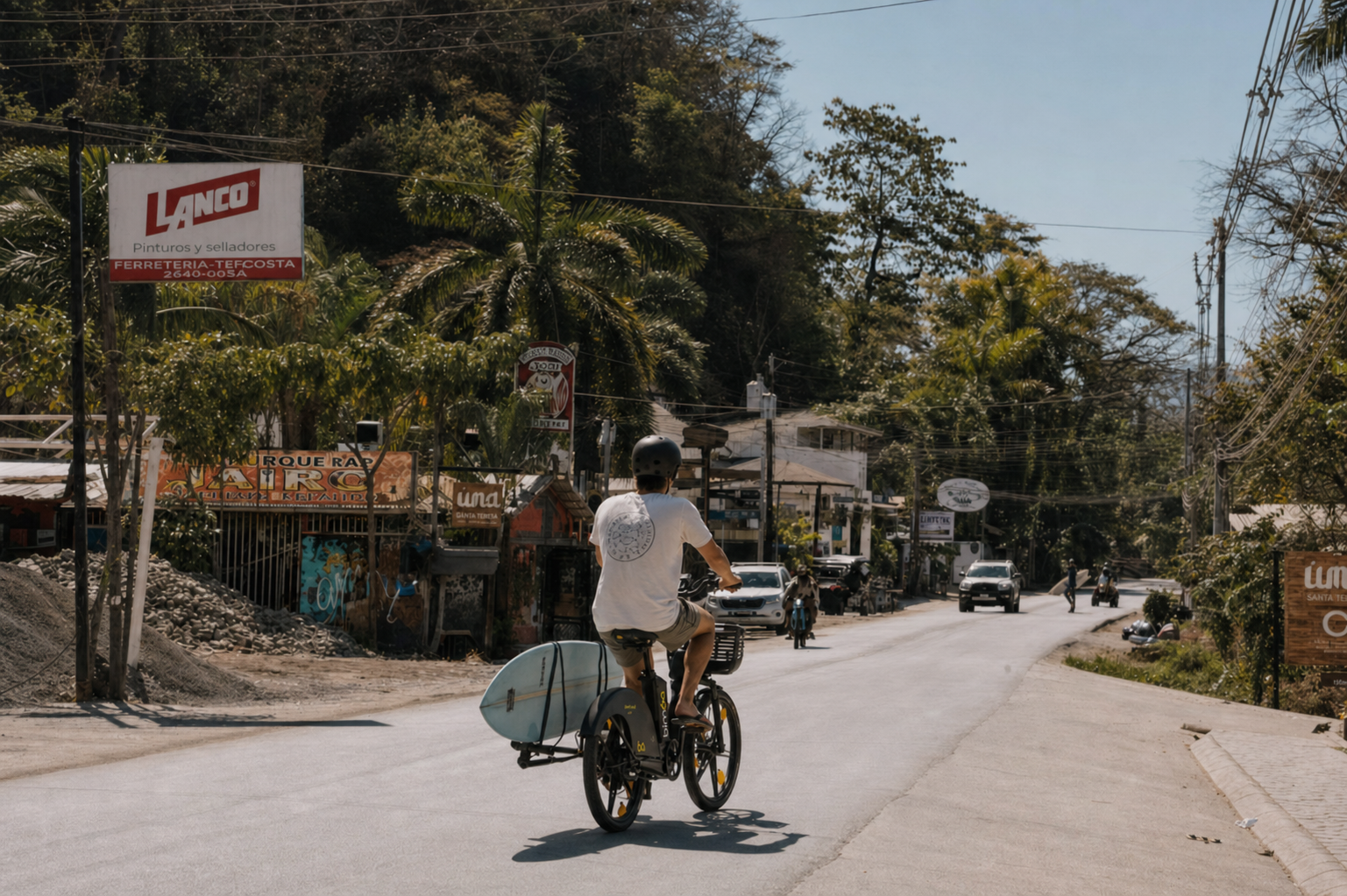 Longboard surfer walking near the Santa Teresa beach road